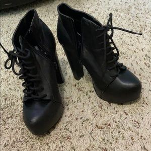 High heeled black lace up booties